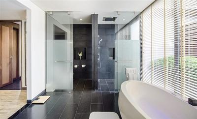 Bathroom with bathtub and shower in a pool villa