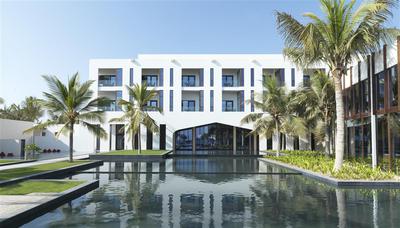 External view of resort building with palm trees