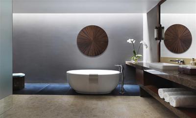 Bathtub with bathing amenities and wall art