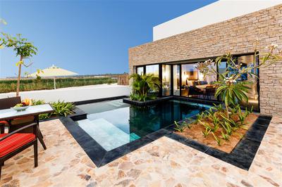 Villa exterior with pool and view of the lagoon