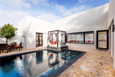 Villa exterior with pool, cabana and sitting area