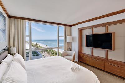One King & Two Queen Beds with Balcony & Partial Ocean View